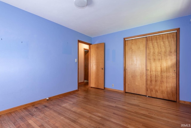644 W Ladd Ave, Bloomington, IN 47403 - unfurnished bedroom with wood finished floors and a closet