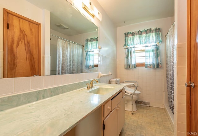 644 W Ladd Ave, Bloomington, IN 47403 - full bath featuring vanity, healthy amount of natural light, tile walls, and curtained shower