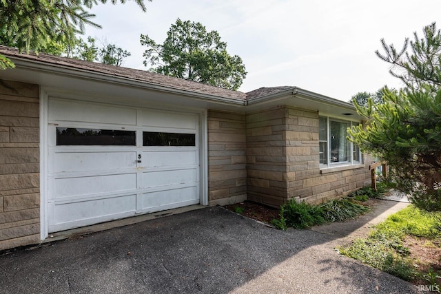 644 W Ladd Ave, Bloomington, IN 47403 - view of property exterior with driveway and an attached garage