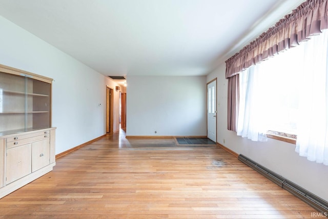 644 W Ladd Ave, Bloomington, IN 47403 - spare room featuring a baseboard heating unit and light wood-style flooring