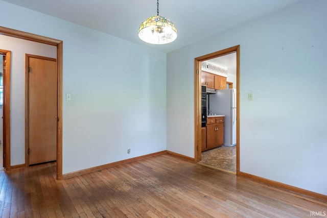 644 W Ladd Ave, Bloomington, IN 47403 - unfurnished room with hardwood / wood-style floors and baseboards