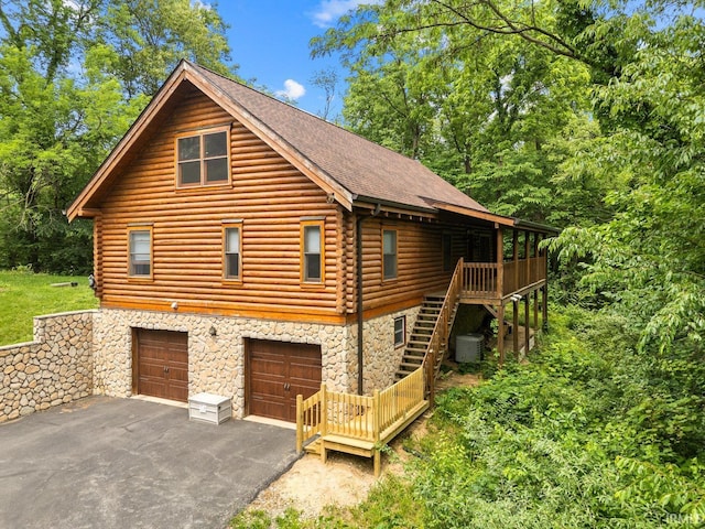 5818 Prophets Rock Rd, West Lafayette, IN 47906 - view of side of property with stairs, stone siding, asphalt driveway, and log siding