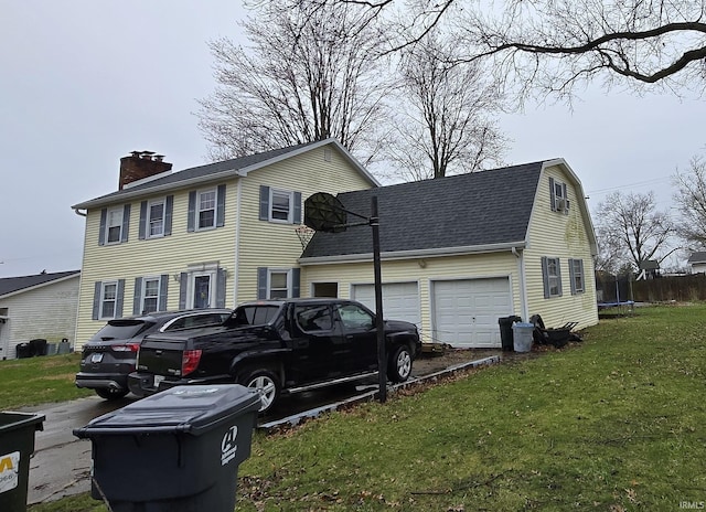 1403 Wilson St, Boonville, IN 47601 - view of front of house with a trampoline, a chimney, a garage, a front lawn, and roof with shingles