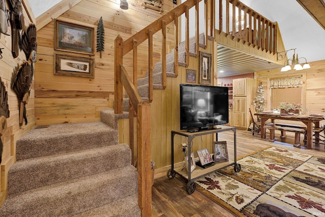 10154 W Rock E Rd, Bloomington, IN 47403 - stairway with wooden walls, wood finished floors, a chandelier, and lofted ceiling
