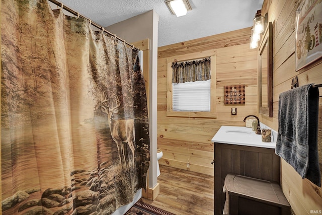 10154 W Rock E Rd, Bloomington, IN 47403 - bathroom with wooden walls, vanity, wood finished floors, a textured ceiling, and a shower with shower curtain