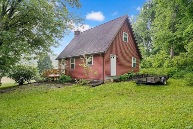 10154 W Rock E Rd, Bloomington, IN 47403 - view of home's exterior with a chimney, a wooden deck, a yard, and roof with shingles