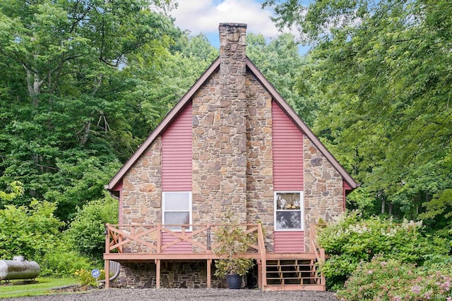 10154 W Rock E Rd, Bloomington, IN 47403 - back of property featuring stone siding, a chimney, and a deck