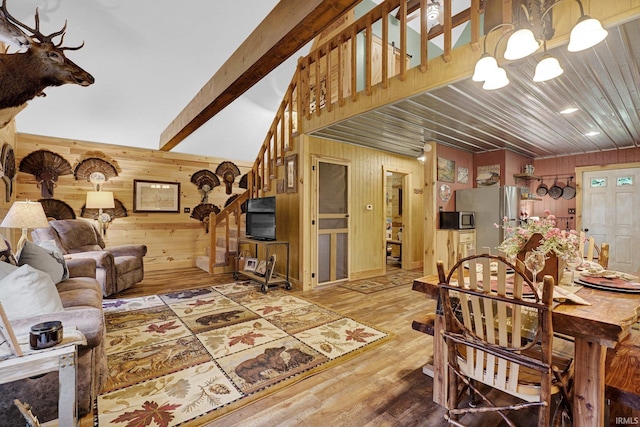 10154 W Rock E Rd, Bloomington, IN 47403 - living area featuring wooden walls, wood finished floors, and a chandelier
