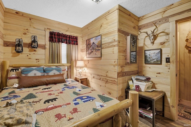 10154 W Rock E Rd, Bloomington, IN 47403 - bedroom featuring wooden walls, a textured ceiling, and wood finished floors