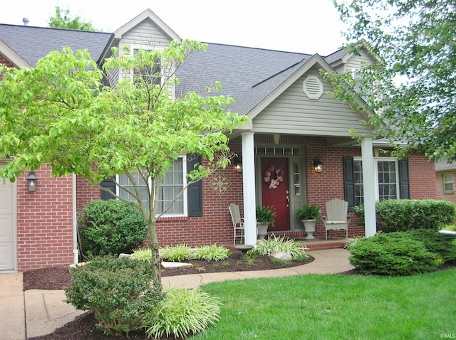 2622 Oak Trail Dr, Newburgh, IN 47630 - view of front facade featuring a porch, brick siding, and roof with shingles
