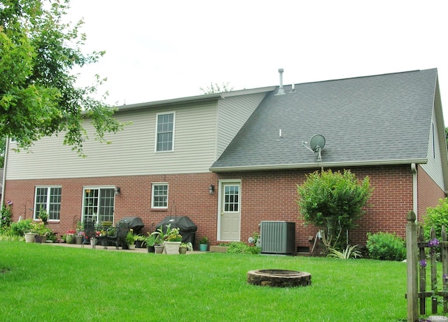 2622 Oak Trail Dr, Newburgh, IN 47630 - rear view of house featuring a fire pit, brick siding, and a lawn