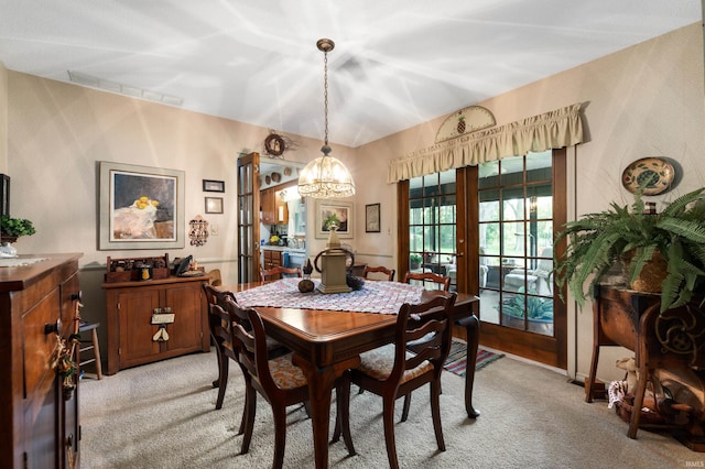 1105 N Buckeye Rd, Muncie, IN 47304 - dining area with light carpet and a chandelier