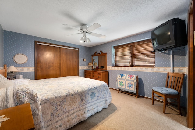 1105 N Buckeye Rd, Muncie, IN 47304 - carpeted bedroom with wallpapered walls, a closet, and a ceiling fan