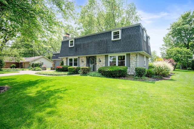 1105 N Buckeye Rd, Muncie, IN 47304 - colonial inspired home featuring stone siding, roof with shingles, mansard roof, and a front yard
