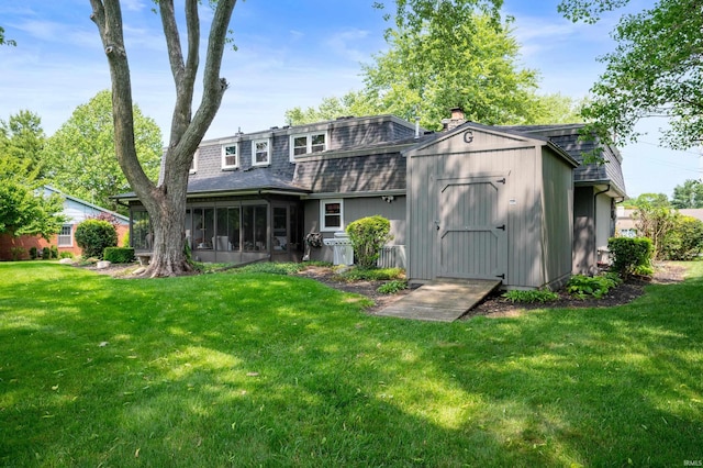 1105 N Buckeye Rd, Muncie, IN 47304 - back of property with a storage shed, a yard, a chimney, a sunroom, and roof with shingles