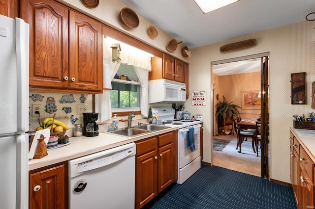1105 N Buckeye Rd, Muncie, IN 47304 - kitchen with white appliances, dark carpet, light countertops, brown cabinetry, and wallpapered walls