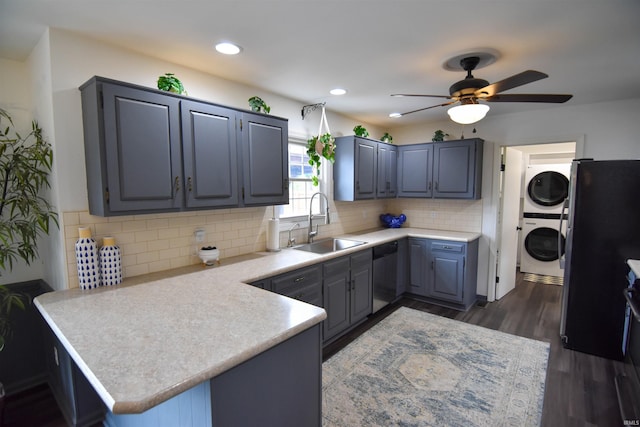 7366 Capri Ct, Newburgh, IN 47630 - kitchen with stacked washing machine and dryer, freestanding refrigerator, stainless steel dishwasher, a peninsula, and ceiling fan