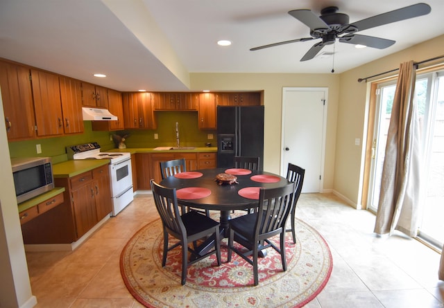 7366 Capri Ct, Newburgh, IN 47630 - kitchen featuring black fridge, electric range, stainless steel microwave, under cabinet range hood, and brown cabinets
