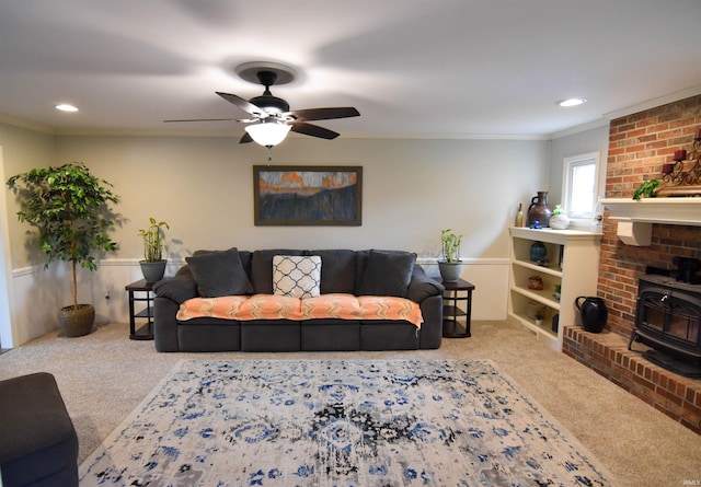 7366 Capri Ct, Newburgh, IN 47630 - carpeted living area featuring a wood stove, a ceiling fan, ornamental molding, and recessed lighting