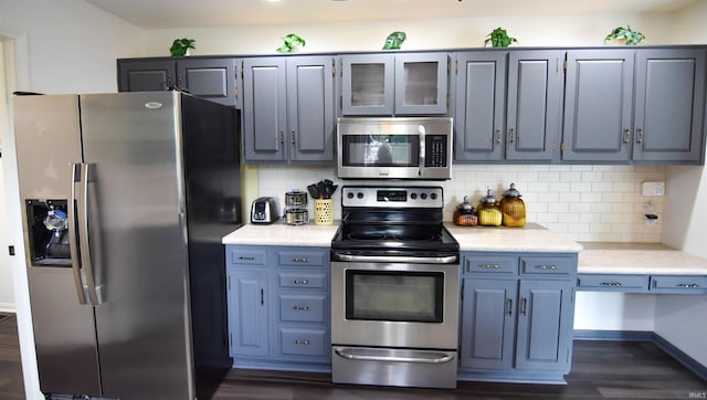 7366 Capri Ct, Newburgh, IN 47630 - kitchen featuring stainless steel appliances, light countertops, dark wood-style floors, and decorative backsplash
