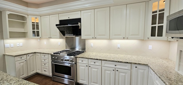 1648 S Ira St, Bloomington, IN 47401 - kitchen with appliances with stainless steel finishes, extractor fan, tasteful backsplash, and light stone countertops