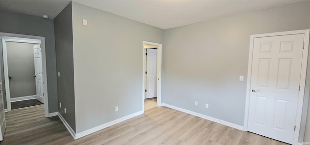 1648 S Ira St, Bloomington, IN 47401 - unfurnished bedroom with wood finished floors and a walk in closet