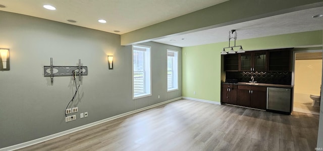 1648 S Ira St, Bloomington, IN 47401 - bar with wood finished floors, decorative backsplash, recessed lighting, dishwasher, and fridge