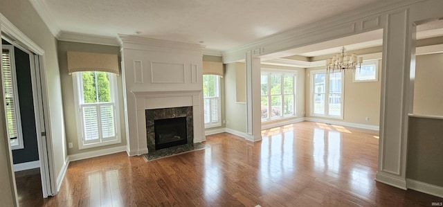 1648 S Ira St, Bloomington, IN 47401 - unfurnished living room featuring a chandelier, wood finished floors, a premium fireplace, and crown molding