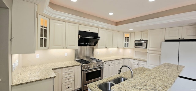 1648 S Ira St, Bloomington, IN 47401 - kitchen with stainless steel appliances, under cabinet range hood, backsplash, recessed lighting, and glass insert cabinets