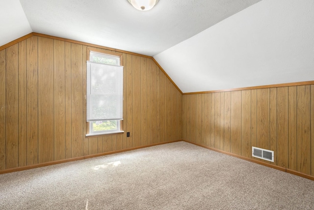 605 N 7th St, Goshen, IN 46528 - bonus room with healthy amount of natural light, lofted ceiling, carpet, and wood walls