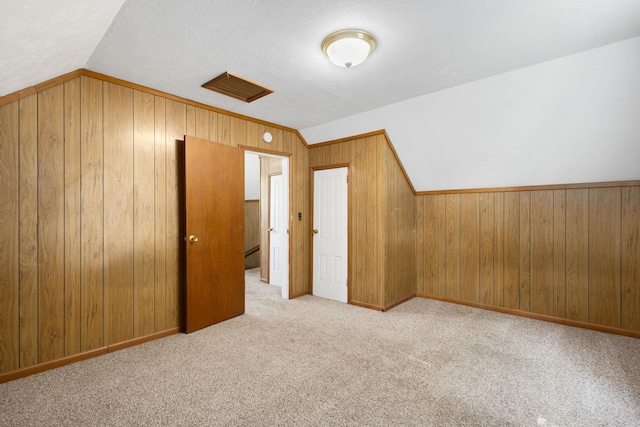605 N 7th St, Goshen, IN 46528 - additional living space with lofted ceiling, wood walls, and carpet floors