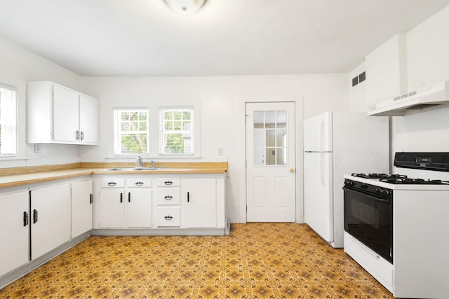 605 N 7th St, Goshen, IN 46528 - kitchen with gas stove, under cabinet range hood, white cabinetry, and light countertops