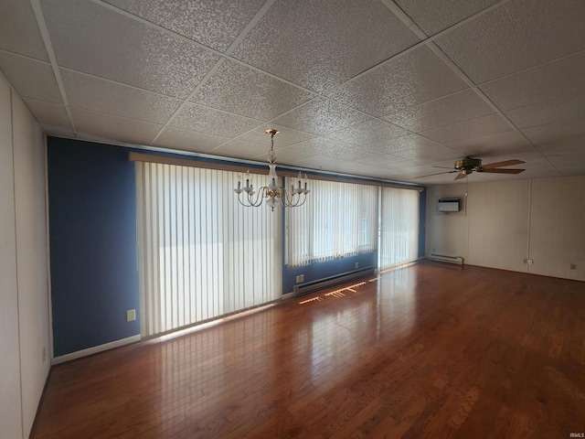 6480 E Mcguire Rd, Churubusco, IN 46723 - unfurnished room with an AC wall unit, wood finished floors, a paneled ceiling, a chandelier, and ceiling fan