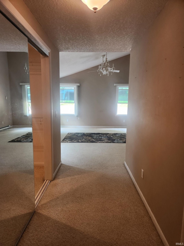 6480 E Mcguire Rd, Churubusco, IN 46723 - corridor with carpet floors, a textured ceiling, lofted ceiling, and a chandelier