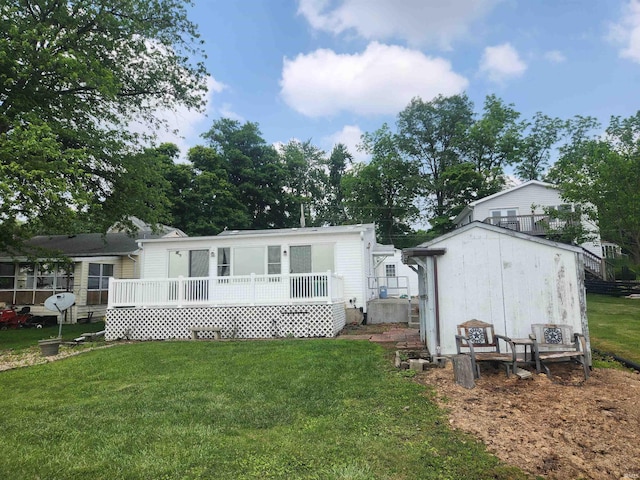 6480 E Mcguire Rd, Churubusco, IN 46723 - rear view of house with a lawn, a wooden deck, and an outdoor structure