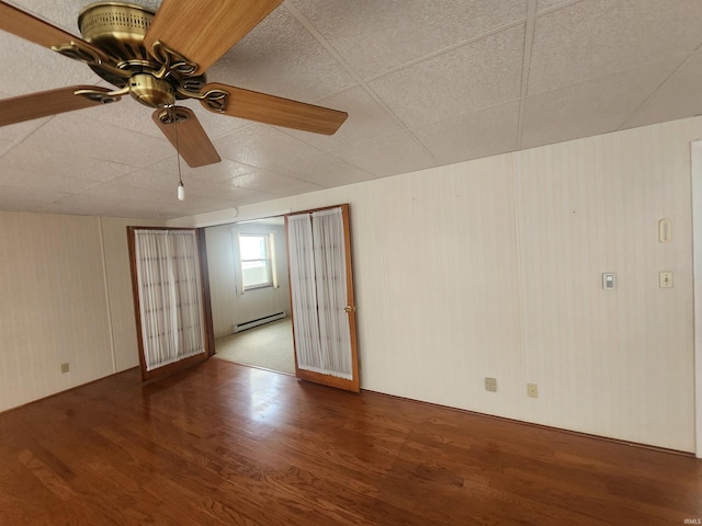 6480 E Mcguire Rd, Churubusco, IN 46723 - empty room featuring wood finished floors, a baseboard radiator, and a ceiling fan