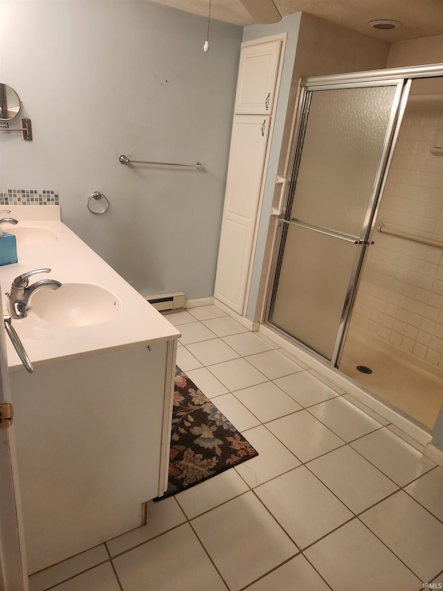 6480 E Mcguire Rd, Churubusco, IN 46723 - bathroom featuring tile patterned floors, a shower stall, double vanity, and baseboard heating