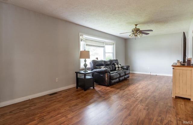 4260 W 3rd St, Bloomington, IN 47404 - living room with a textured ceiling, a ceiling fan, and dark wood-style flooring