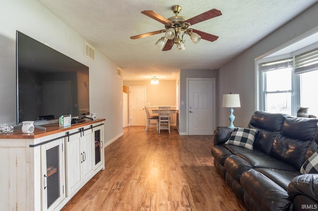 4260 W 3rd St, Bloomington, IN 47404 - living area featuring a textured ceiling, light wood-style flooring, and a ceiling fan