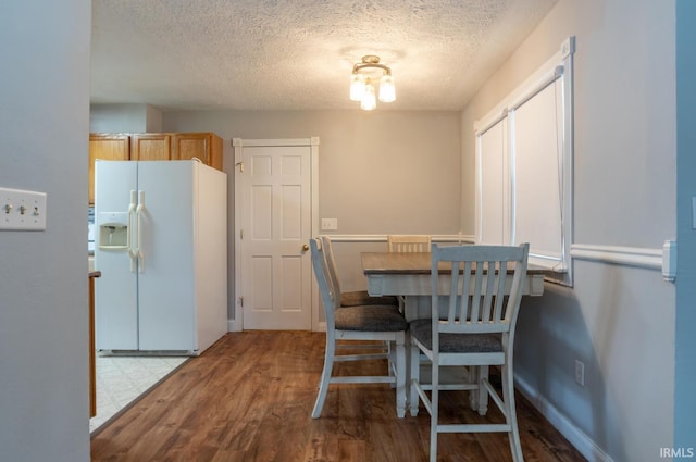 4260 W 3rd St, Bloomington, IN 47404 - dining room featuring a textured ceiling and wood finished floors