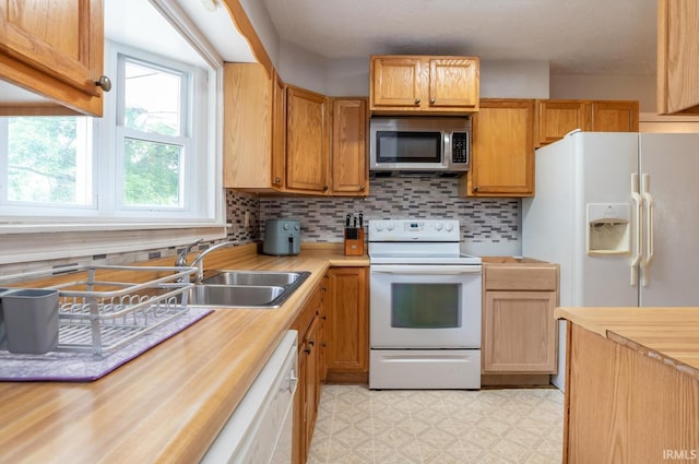 4260 W 3rd St, Bloomington, IN 47404 - kitchen featuring white appliances, light flooring, wood counters, and tasteful backsplash