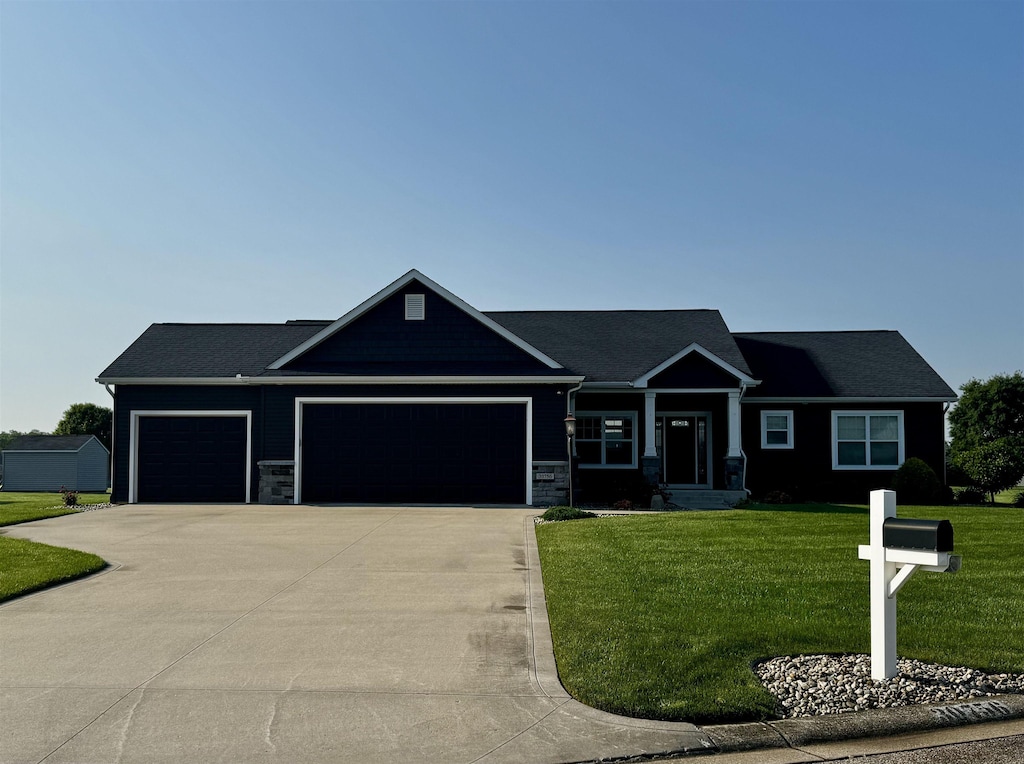 30756 Sandy Creek Dr, Granger, IN 46530 - craftsman-style house featuring a garage, driveway, a front lawn, and stone siding