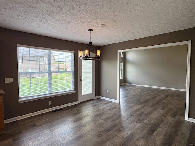 222 Sinclair Dr, West Lafayette, IN 47906 - unfurnished dining area with a chandelier, dark wood-style floors, healthy amount of natural light, and a textured ceiling