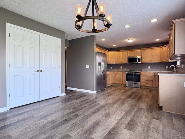 222 Sinclair Dr, West Lafayette, IN 47906 - kitchen with appliances with stainless steel finishes, a chandelier, dark wood-style floors, a textured ceiling, and light countertops