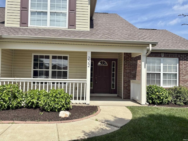 222 Sinclair Dr, West Lafayette, IN 47906 - doorway to property featuring a shingled roof, brick siding, and a porch