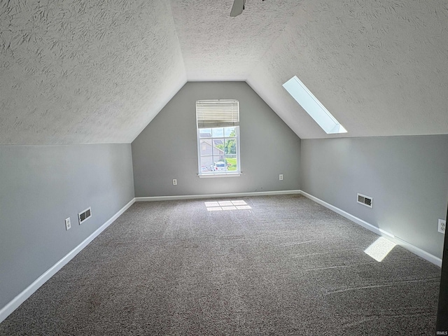 222 Sinclair Dr, West Lafayette, IN 47906 - bonus room with a textured ceiling, a skylight, carpet, and vaulted ceiling