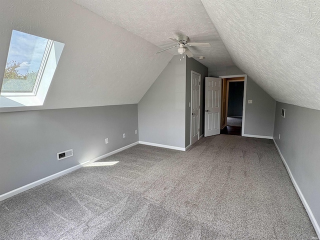 222 Sinclair Dr, West Lafayette, IN 47906 - bonus room featuring a textured ceiling, carpet flooring, vaulted ceiling, and ceiling fan