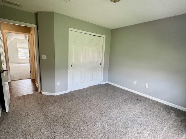 222 Sinclair Dr, West Lafayette, IN 47906 - unfurnished bedroom with dark colored carpet and a closet