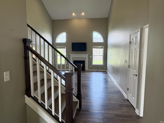222 Sinclair Dr, West Lafayette, IN 47906 - foyer featuring a fireplace, stairway, dark wood-type flooring, a high ceiling, and recessed lighting
