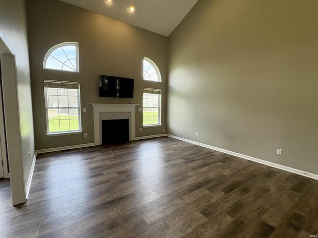 222 Sinclair Dr, West Lafayette, IN 47906 - unfurnished living room featuring healthy amount of natural light, high vaulted ceiling, dark wood-type flooring, a fireplace, and recessed lighting